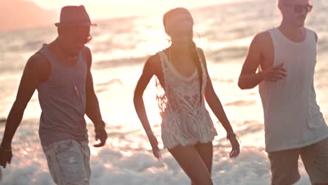 young multi-ethnic friends having fun walking on the beach