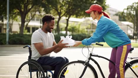 a joyful interaction: a smiling man in a wheelchair receives a pair of shoes from a woman riding a bicycle, celebrating friendship, support, and active lifestyle