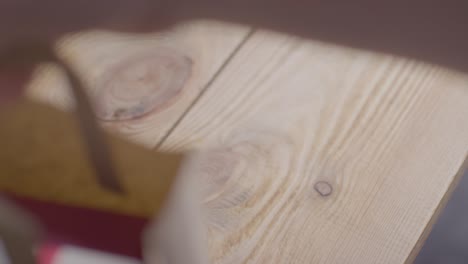 close up of man taking romantic valentines present of perfume and gift wrap box from bag