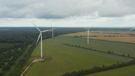 close up of a rotating wind turbine with wind turbine park in the background