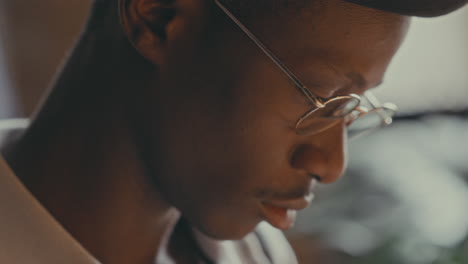 close-up portrait of a young man wearing glasses
