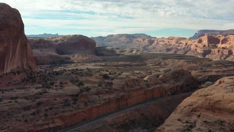 aerial drone shot of rock formation canyon at sunset in utah, usa