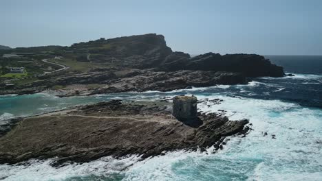 Waves-whitewash-breaking-at-La-Pelosa-Tower,-Sardinia