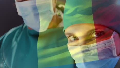 animation of flag of belgium waving over surgeon in operating theatre