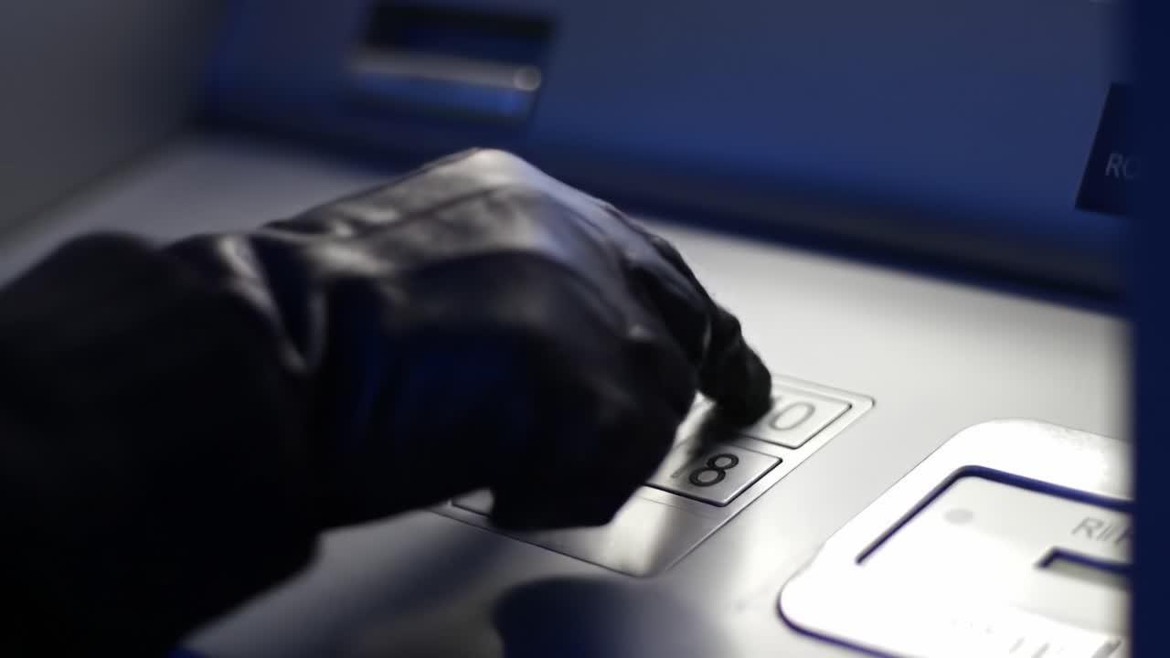 A Mysterious Hand in Black Gloves Interacts with an ATM, Typing in PIN Codes and Potentially Engaging in Suspicious Activity Under Dim Light Conditions