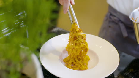 Cook-Preparing-Pasta-Dish-In-Italian-Restaurant-2