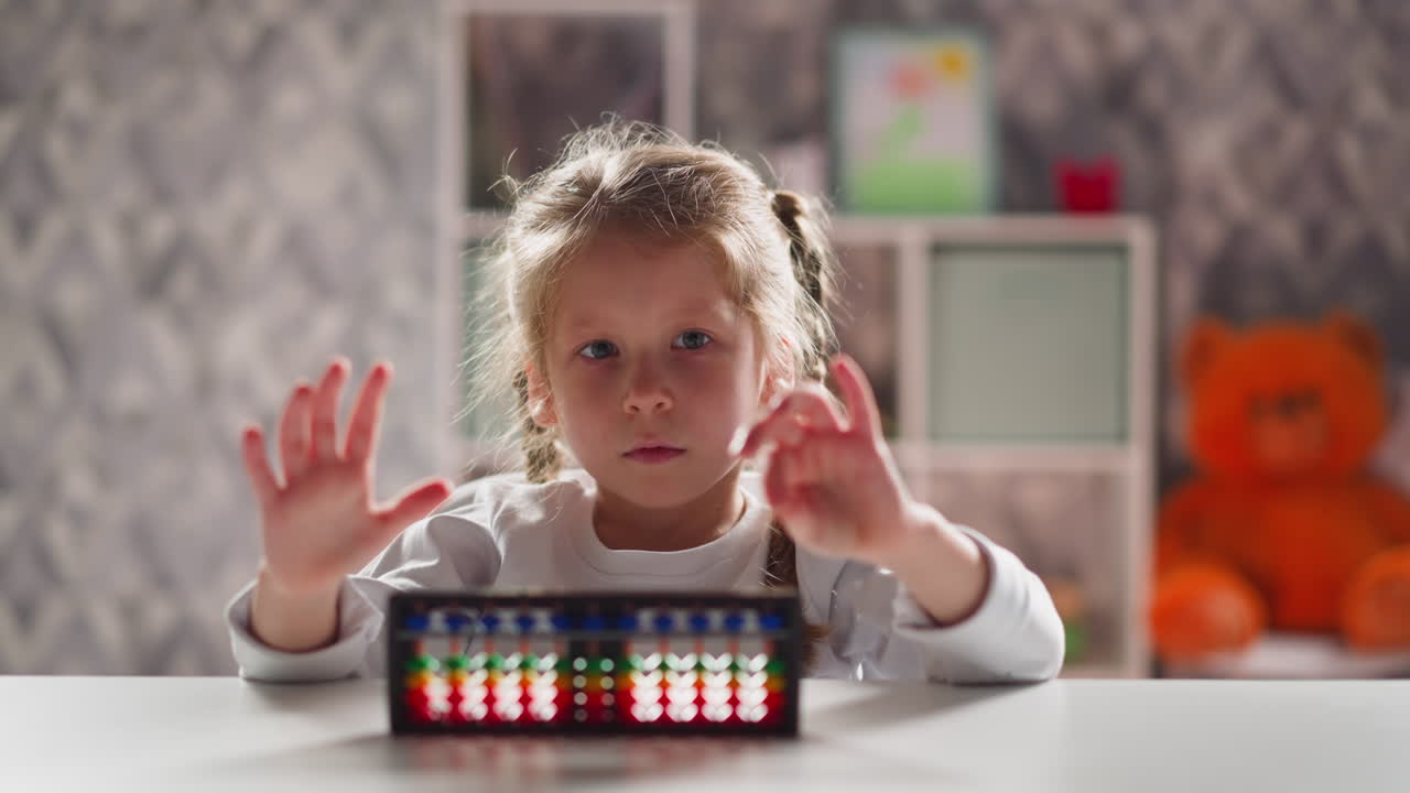 Little girl student with abacus does exercises for fingers