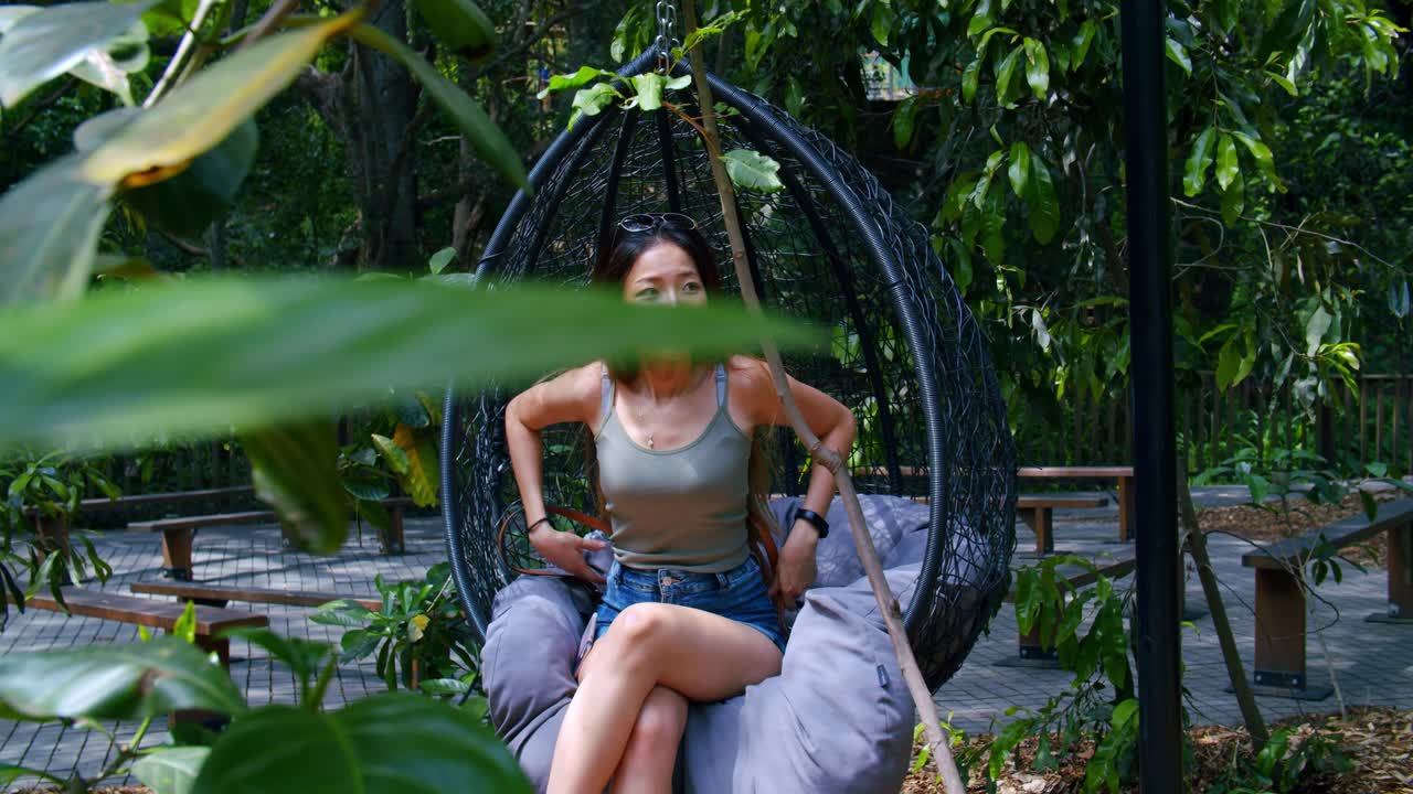 Malaysian Woman Swinging in An Outdoor Hanging Chair, SLOW MOTION
