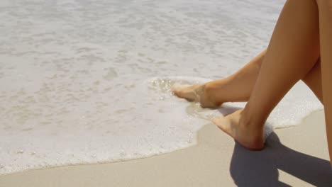Low-section-of-woman-relaxing-on-the-beach-4k
