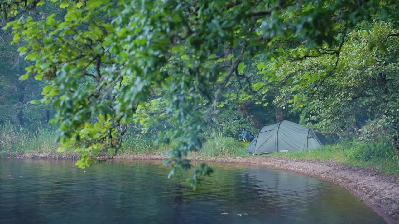 Tent set up on the coastline of Loch Ness, Scotland, on a moody and windy evening