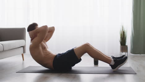 man doing crunches at home