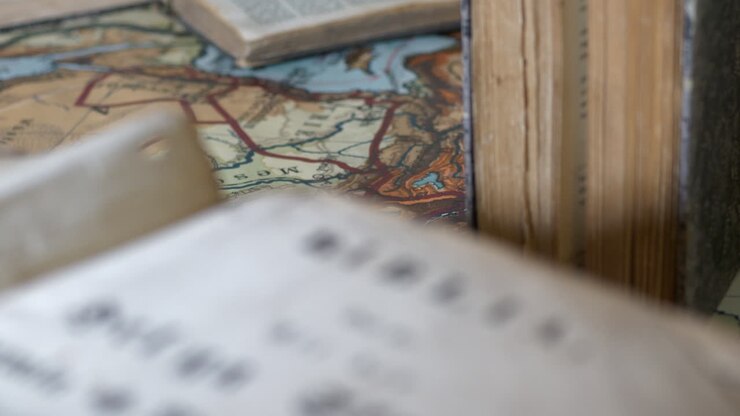 Close-up tilt of ancient Swedish bible, focus shift to other old books