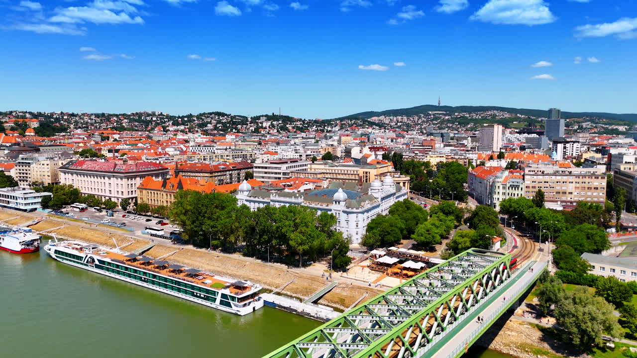 Approaching a metal Old Bridge with a tram going by. Aerial perspective on the beautiful historical part of Bratislava, Slovakia.