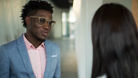 thoughtful african american man talking with colleague