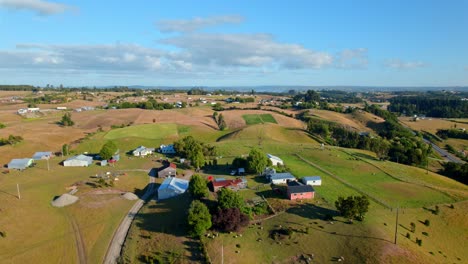 Vista-Aérea-Sobre-Una-Granja-Y-Campos-Rurales-De-Chiloé,-Día-Soleado-En-Chile