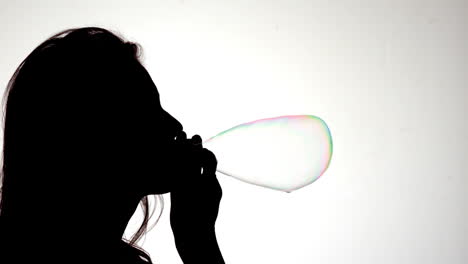 Silhouette-of-attractive-woman-blowing-a-bubble