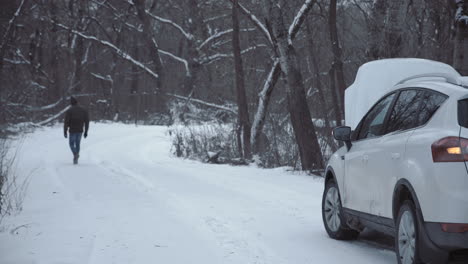 broken down car in snowy forest