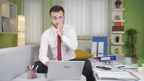 home office worker who is sleepy due to exhaustion is trying not to sleep.