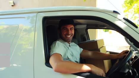 Animation-of-the-words-Free-Delivery-written-over-man-waving-in-a-car-delivering-goods