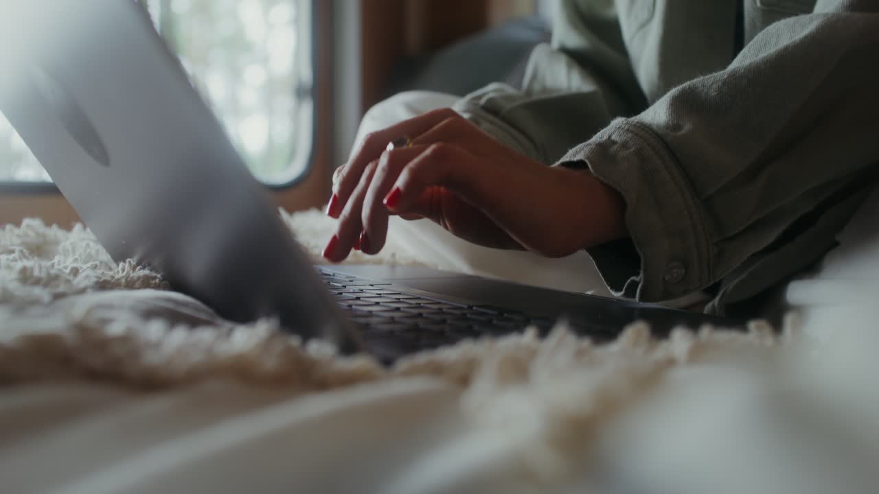 Woman working on laptop in a cozy home environment