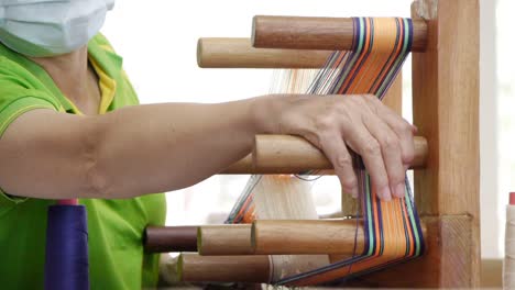 Person-in-face-mask-using-hand-and-fingers