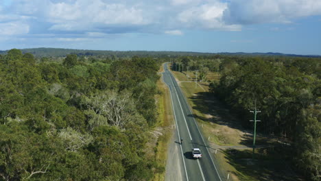 professional cyclist riding road bike along rural highway