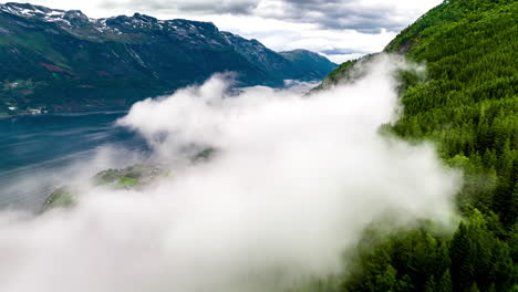 Aerial-hyperlapse-over-mysterious-swirling-mountain-fog,-Hardanger-fjord-Norway