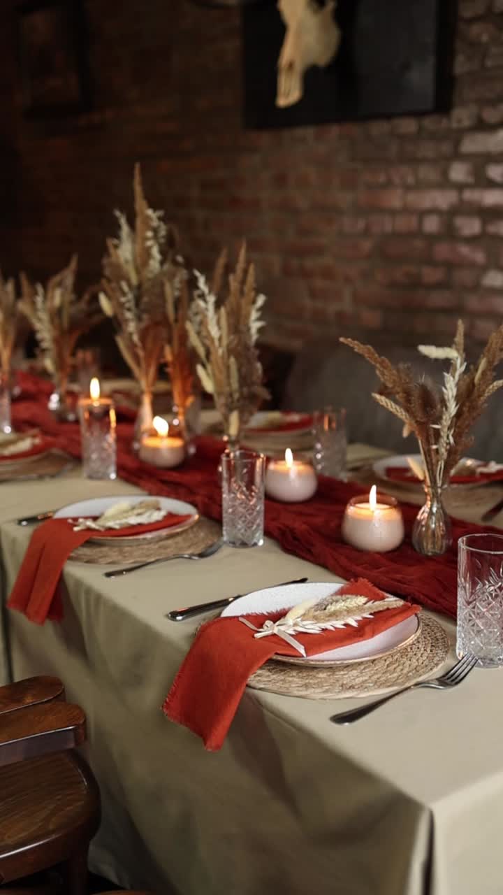 Warm and Festive Dining Table with Autumn Decorations and Flickering Candles
