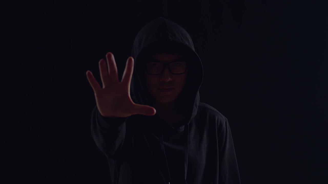 Asian Hacker Showing Stop Hand