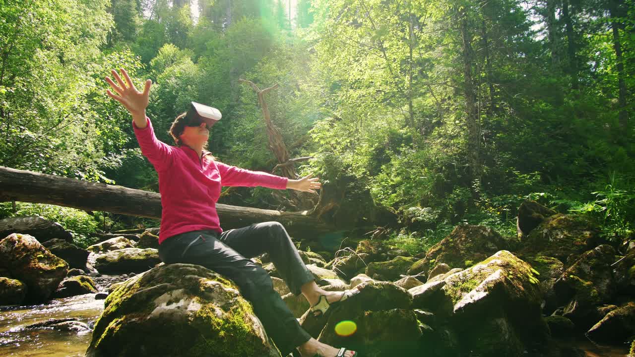 Woman experiencing VR in a scenic forest setting by a river