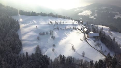 the picturesque church of sveti tomaz on the top of the hill in central slovenia during winter