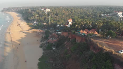 varkala cliff with a sight of the sea and the lush vegetation near the shoreline, in india - aerial panoramic shot