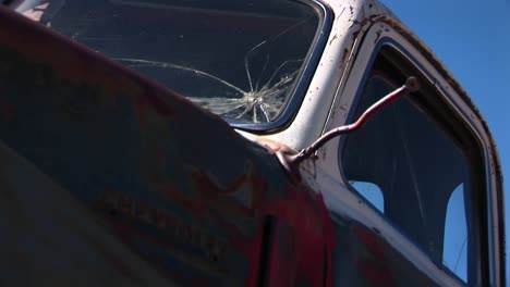 Closeup-Of-Rusted-Pickup-Truck-Cab-With-Broken-Windows-Discarded-And-Littering-The-Utah-Desert