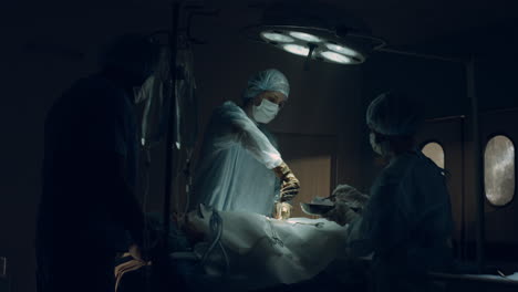 confident surgeon performing operation in dark sterile clinic emergency room.