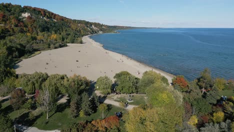 a drone shot of a nearly empty beach on a clear sunny day, bluffers park and beach in ontario canada