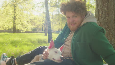 man and his puppy enjoying a sunny day in the park