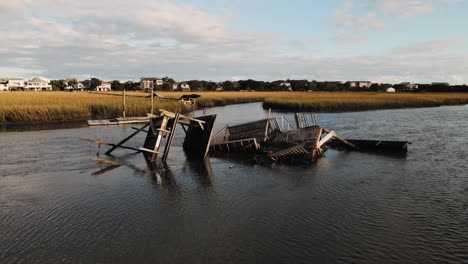 sunset orbit of destroyed dock in pawleys island after hurricane ian water