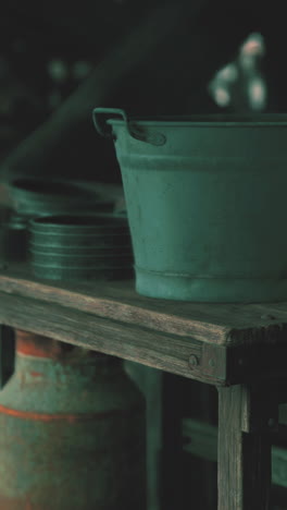 an old metal bucket on a wooden shelf