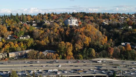 Vibrant-fall-colored-foliage-above-bustling-highway-on-sunny-day-near-St