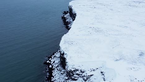 iceland coastline landscape covered in white snow during winter, aerial