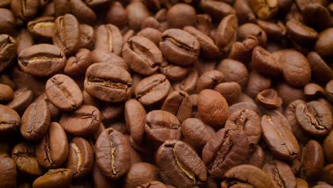 Close-up-of-seeds-of-coffee.-Fragrant-coffee-beans-are-roasted-smoke-comes-from-coffee-beans.