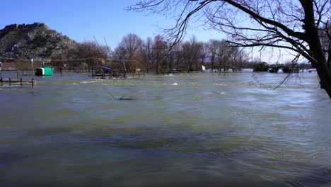 Raging-water-comes-out-of-the-riverbed-and-floods-populated-areas-in-winter