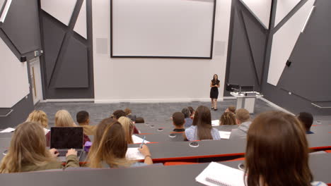 university lecture in lecture theatre, back row student pov