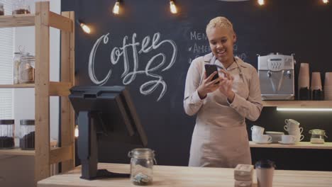 happy mixed race woman selling coffee