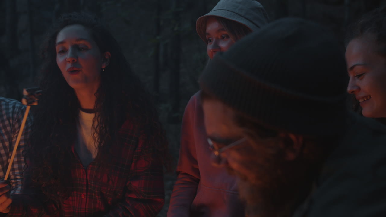 Friends Roasting Marshmallows Around a Campfire