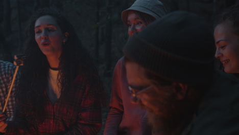 friends roasting marshmallows around a campfire