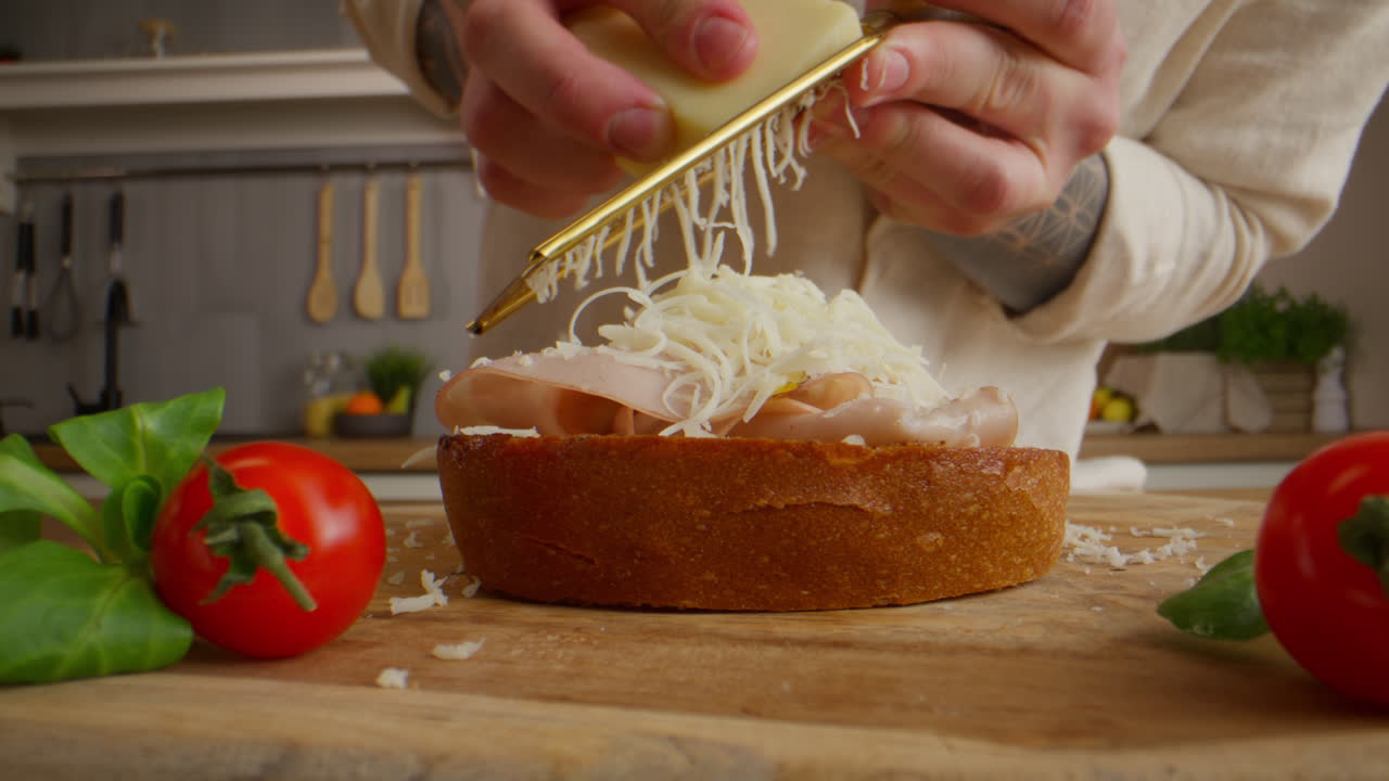 Making a gourmet sandwich with cheese and ham