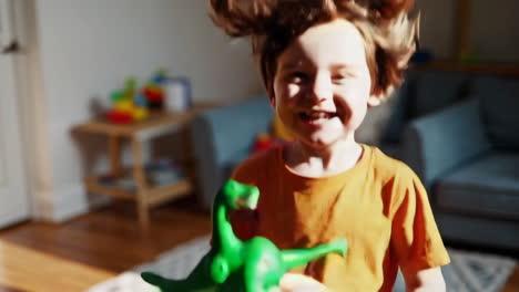 happy child playing with dinosaur toy