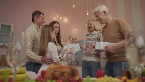 happy family together exchanging christmas presents