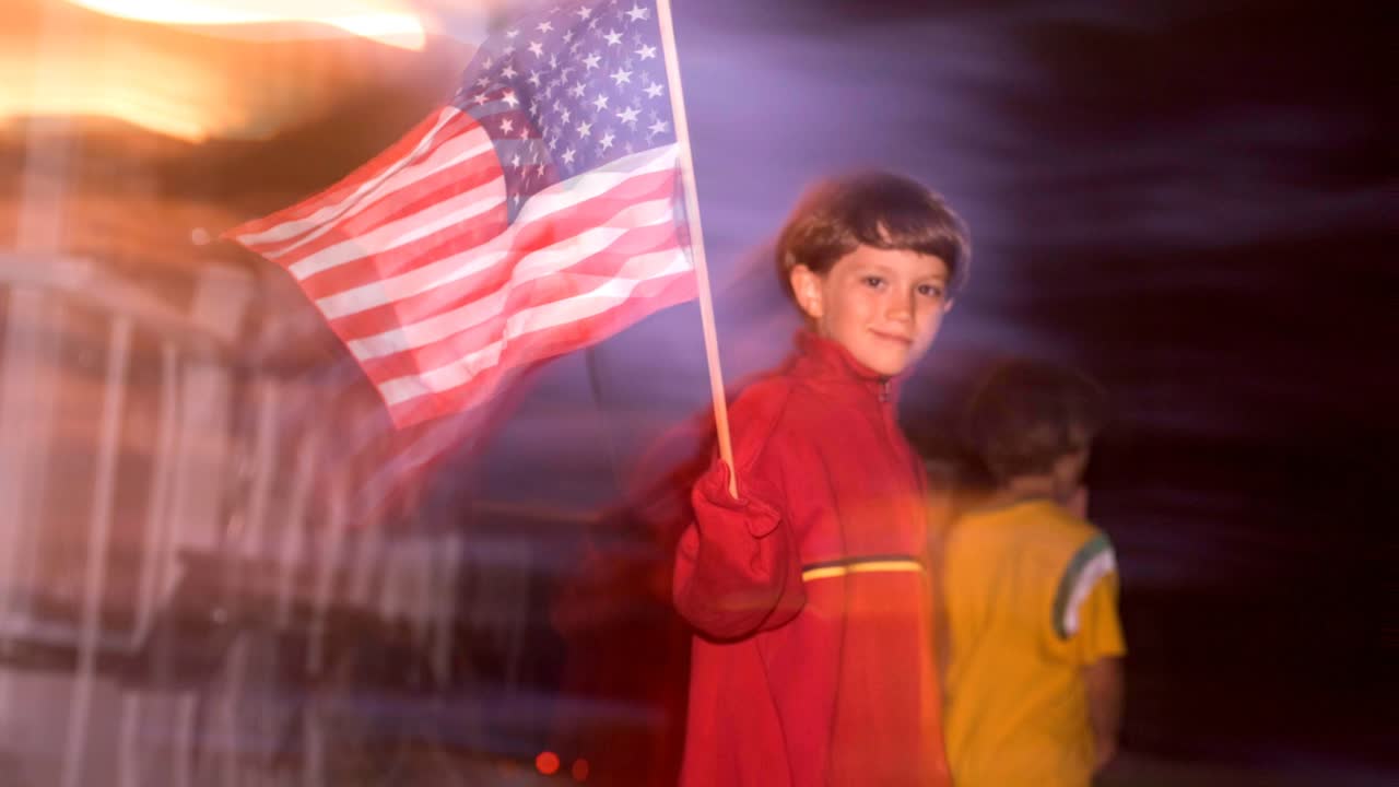 Boy waving American flag